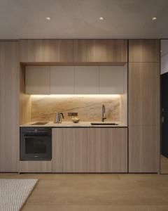 a kitchen with a sink and a stove at Apart-hotel Centr in Sumy
