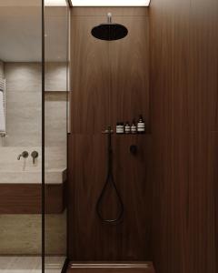 a bathroom with a shower with a glass door at Apart-hotel Centr in Sumy