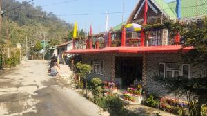 a building with a balcony on the side of a street at SOUPRIYA Impression Homestay in Pedong +21 photos