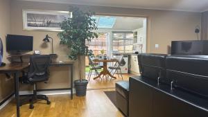 an office with a couch and a desk and a table at Berrow Breeze in Burnham on Sea