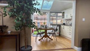 a kitchen with a table and a potted plant at Berrow Breeze in Burnham on Sea