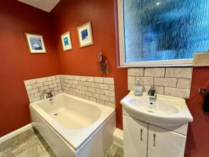 a bathroom with a sink and a bath tub and a sink at Regents Chambers in Bishop Auckland +6 photos