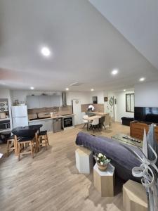 a large living room with a couch and a kitchen at meze34 in Mèze