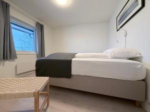 a bedroom with a large bed and a window at apartment With fantastic view and parking in Tromsø