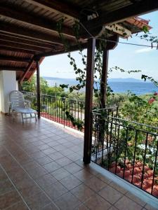 a balcony with a view of the ocean at Anastasia in Áno Lekhónia