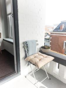 a chair sitting on a balcony next to a window at Villa Kakelbont in Leeuwarden