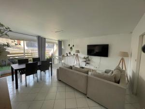 a living room with a couch and a dining room at le Nid d Annie in Sancerre