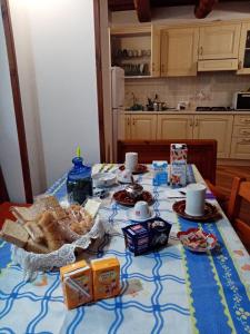 a table with bread and other food on it at Al Nido Del Passero 1 in Greccio