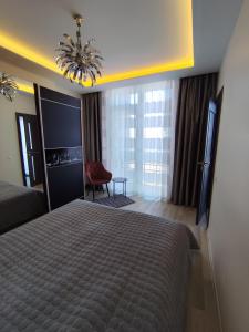 a hotel room with a bed and a chair at Salnas rezidence self check-in in Riga