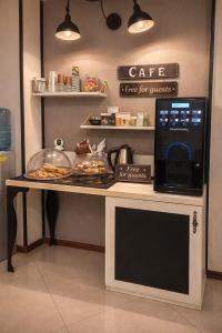 a counter with a table with food and a microwave at Cattleya Boutique Hotel in Ruse