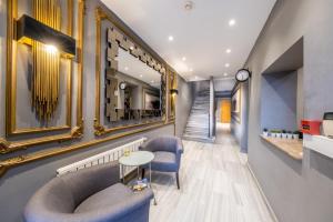 a hallway with a chair and a table and a mirror at King Suite Hotel Beşiktaş in Istanbul