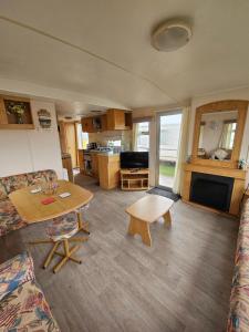 a living room with a couch and a table at Ingoldmells golden sands plot 152 in Ingoldmells