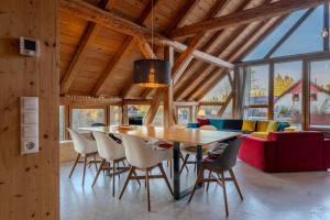a dining room with a wooden table and chairs at Reichart Apartment in Lochau +32 photos