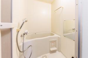 a white bathroom with a shower and a sink at Gran Form Kita 12-jo in Kita-sanjō +86 photos