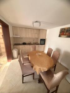 a kitchen with a table and some chairs and a table and a kitchen at Apartman Danilo i Filip in Risan