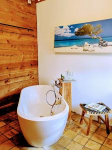 a bathroom with a white bath tub in a room at Liljas Haus im Spreewald in Burg +57 photos