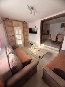 a living room with a couch and a television at Apartman Danilo i Filip in Risan
