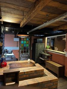 a kitchen with a table and benches in a room at Casa Sabia com charme rústico e belos jardins in Benedito Novo +52 photos