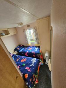 a small bedroom with two beds in a room at Ingoldmells golden sands plot 152 in Ingoldmells