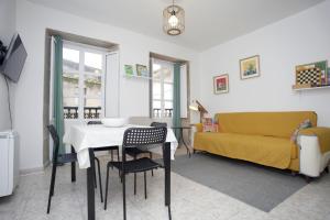 a living room with a table and a couch at Casa do jato in Muros