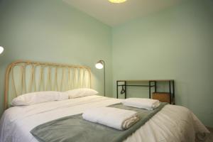 a bedroom with a large bed with two towels on it at Casa do jato in Muros