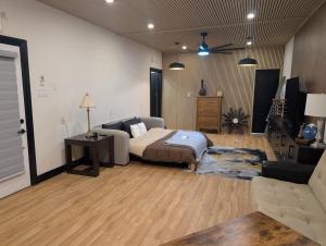 a bedroom with a bed and a living room at Spacious King Pull Out Suite Beamsville in Beamsville