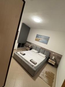 a bedroom with a large bed in a room at Teddy Apartment in Durrës