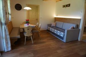 a small room with a bed and a dining table at Niederhaushof in Santa Valpurga +46 photos