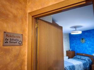 a bedroom with a door with a sign on it at Casa el Alfar mudéjar in Teruel