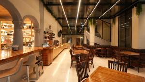 a restaurant with wooden tables and chairs and a bar at Hotel Marques Del Valle in Oaxaca City