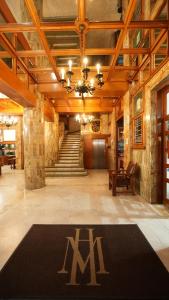a large lobby with a m sign on the floor at Hotel Marques Del Valle in Oaxaca City