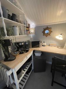 a kitchen with a counter with a coffee maker on it at Granbo station in Granbo