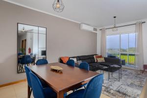 a living room with a table and chairs and a couch at Azorina Lodge in Ponta Delgada
