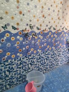 a tiled wall with a wall with balls on it at Balaji hotel in Badrinath