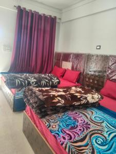 a room with a bed and a couch with curtains at Balaji hotel in Badrinath
