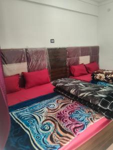 two beds sitting next to each other in a room at Balaji hotel in Badrinath