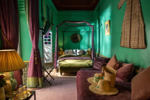 a green room with a bed and a couch at Riad Dar Al Assad in Marrakesh +289 photos