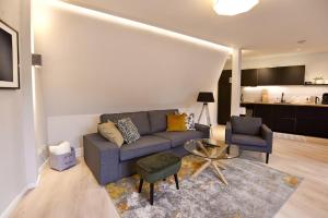 a living room with a couch and two chairs and a table at Sehr gemütlich und modern in Haldensleben