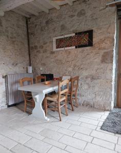 a white table and chairs on a patio at La Maison d'ART in Lacour +23 photos