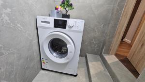 a washing machine in a room with at Garden Lemon Tree Villa in Tirana