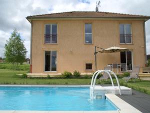 a villa with a swimming pool in front of a house at Cosy vacation home near the sea in Verdun