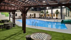 a swimming pool with a checkeredkered table next to it at Holiday Inn Great Falls-Convention Center by IHG in Great Falls