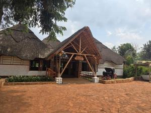 a house with a thatched roof at Across The Nile Resort Jinja in Njeru