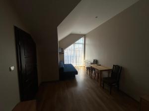 a room with a table and chairs and a window at Hotel Eliot in Łomża