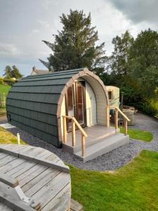 a dome tent with a deck in a yard at Siabod Huts in Betws-y-coed