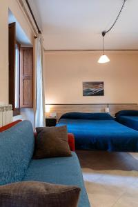 a living room with two beds and a couch at Bed and Breakfast L'Annunziata in Sulmona +73 photos