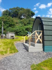 a dome shaped building with a porch and a deck at Siabod Huts in Betws-y-coed