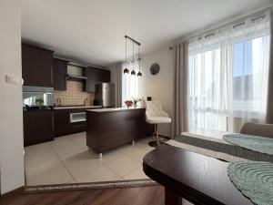 a room with a kitchen and a bedroom at Gustowny apartament in Inowrocław +7 photos