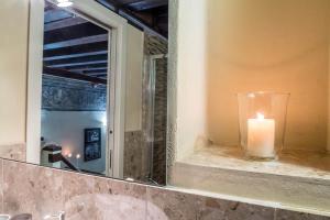 a candle sitting on a counter in front of a mirror at Palazzo Duomo in Verona +56 photos