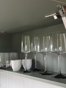 a row of wine glasses sitting on a shelf at Villa D Castro in Gonçalves +8 photos